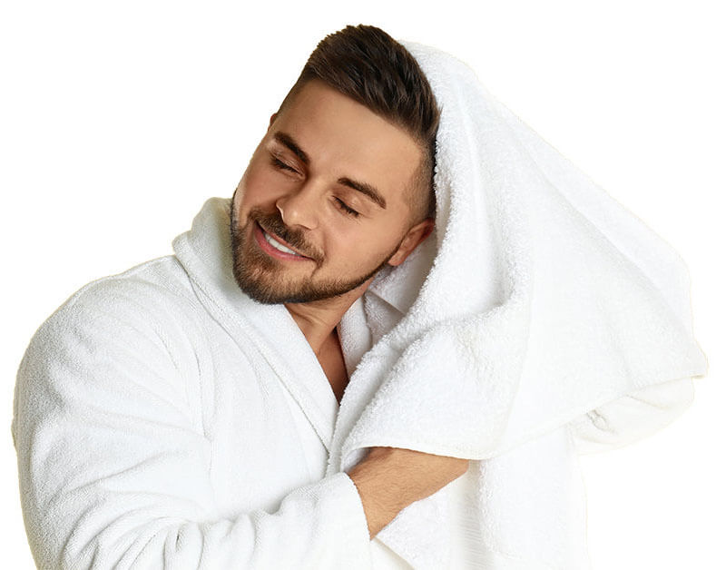 man in white bath robe wiping hair with white towel 